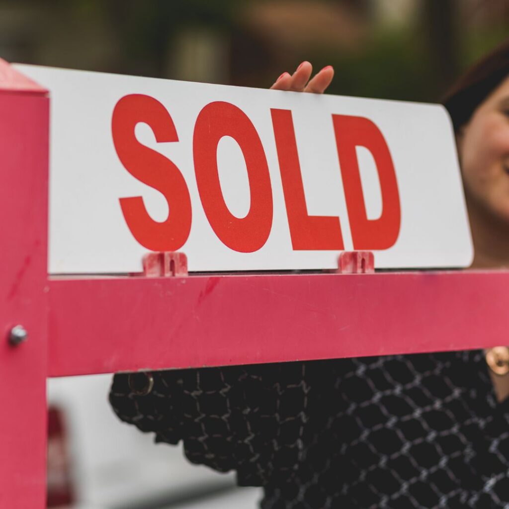 a sold sign in front of a home