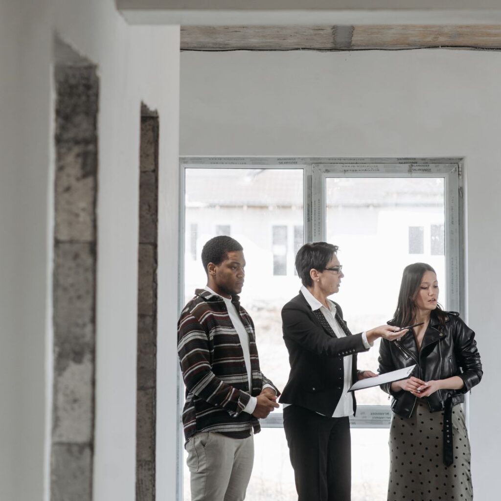 a real estate agent showing her clients around a new home