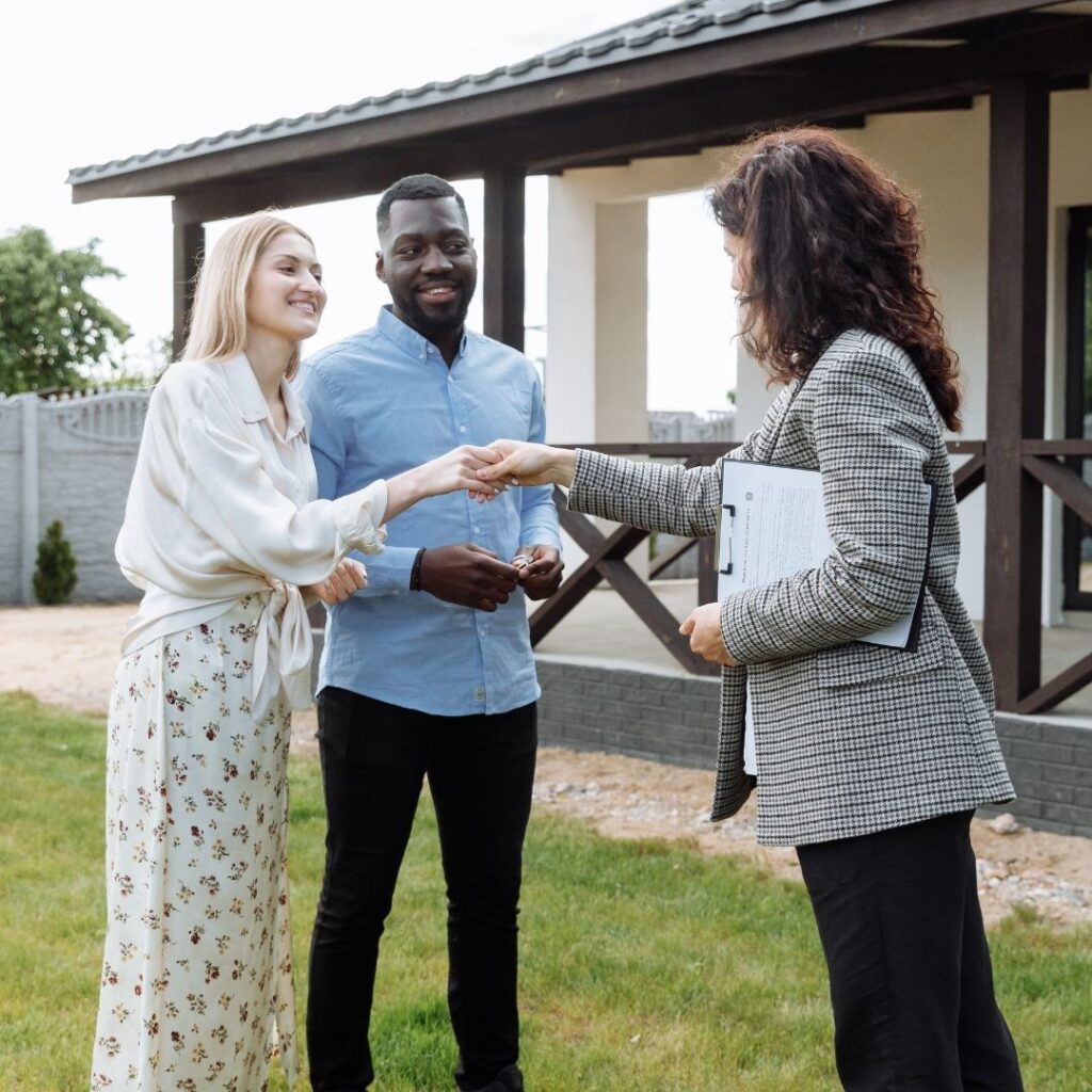 new homeowners handshake with realtor